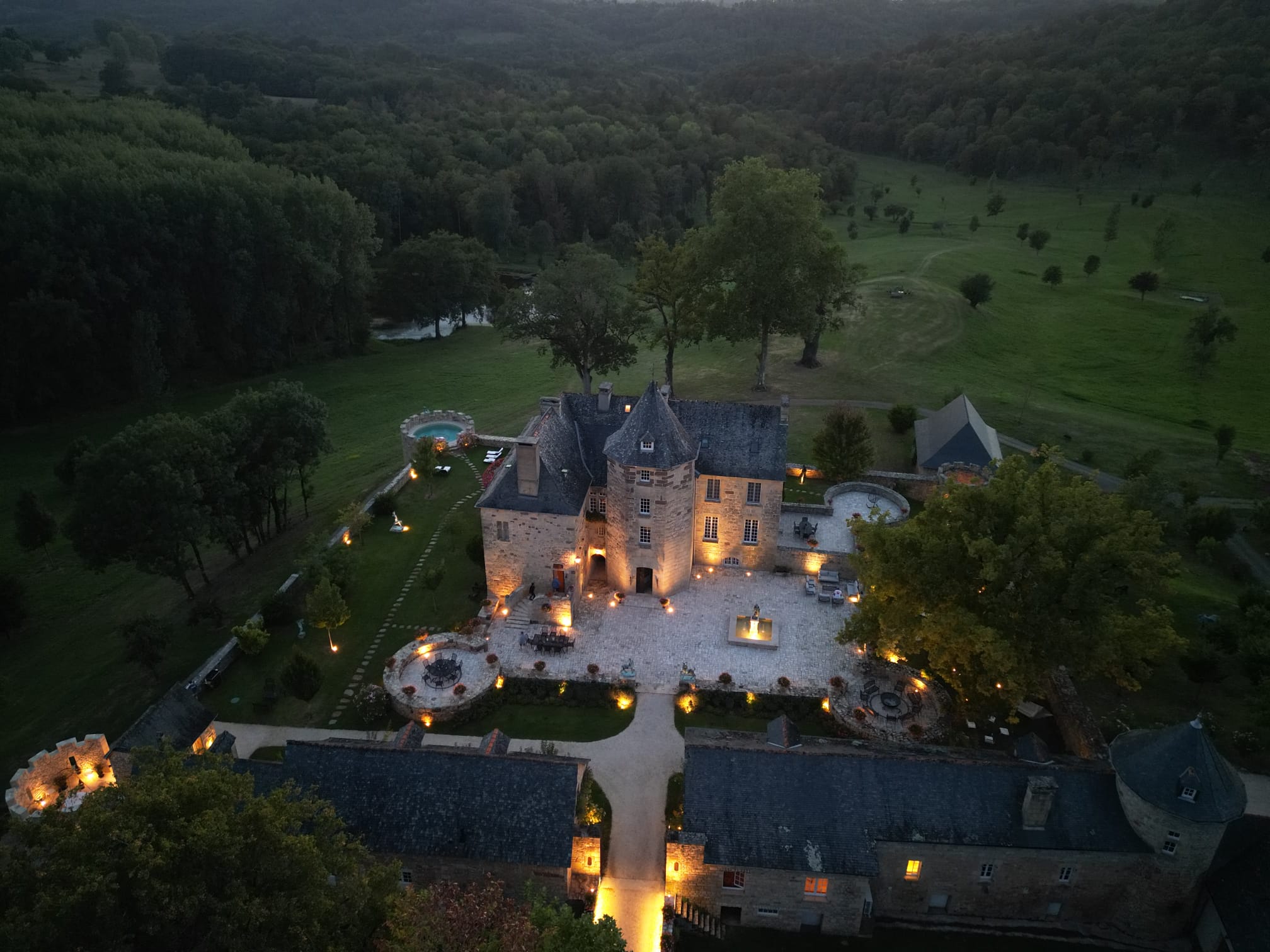 Aerial view of Château de Lons illuminated at dusk